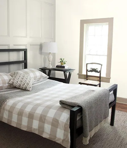 Bedroom with Benjamin Moore Simply White walls, Indian River 985 trim, and Classic Gray CC-23 paneling