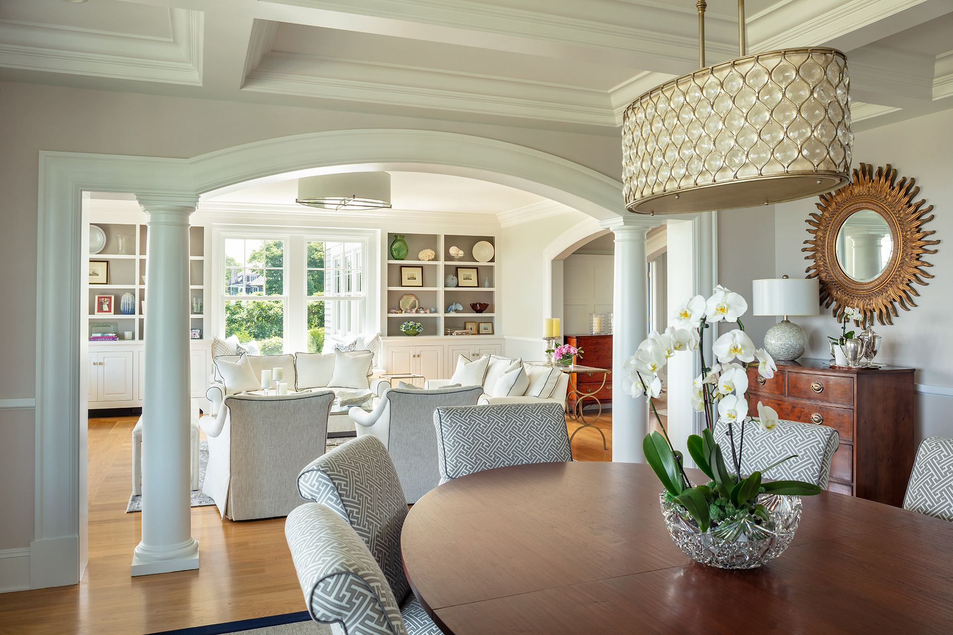 Benjamin Moore Sea Salt CSP-95 provides continuity and warmth as the backdrop for a living room and dining room.