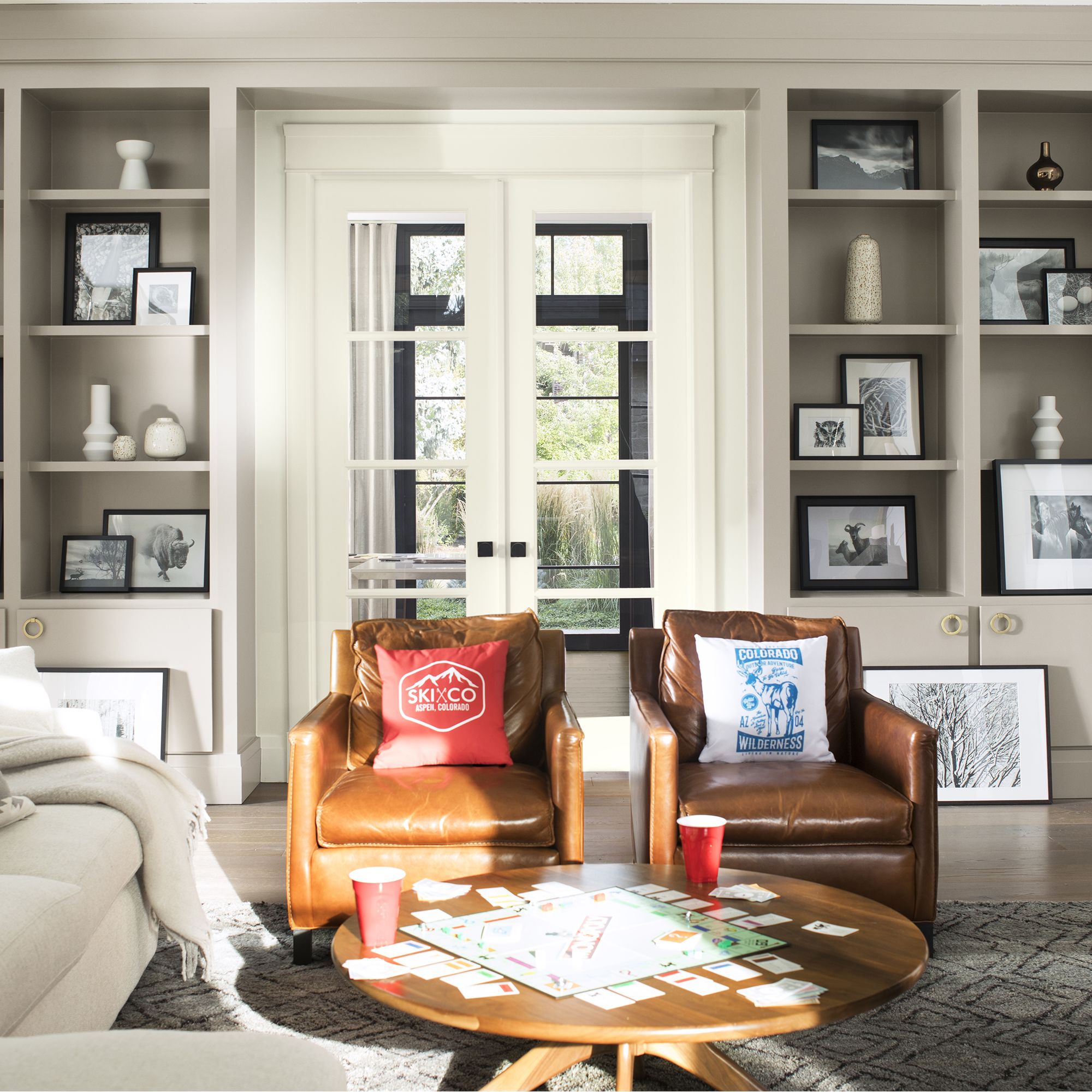 Living Room in Benjamin Moore Cloud White walls and Cloud White trim with Benjamin Moore Silver Fox 2108-50 built-in shelves