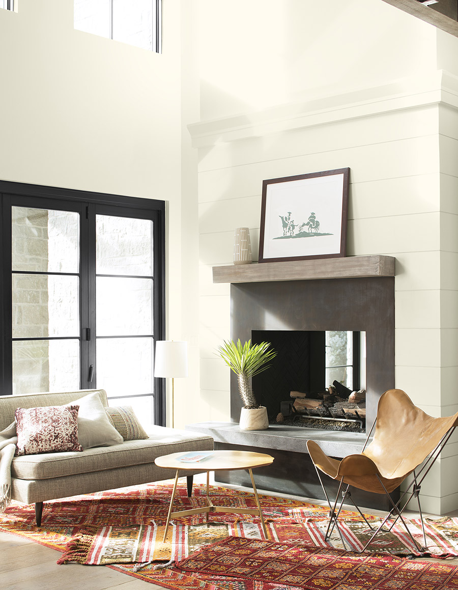 Living room with Benjamin Moore Cloud White walls and matching Cloud White trim, door in Benjamin Moore Black Satin 2131-10