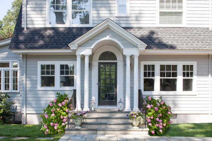 Exterior siding in Benjamin Moore Coventry Gray, front door in Jet Black