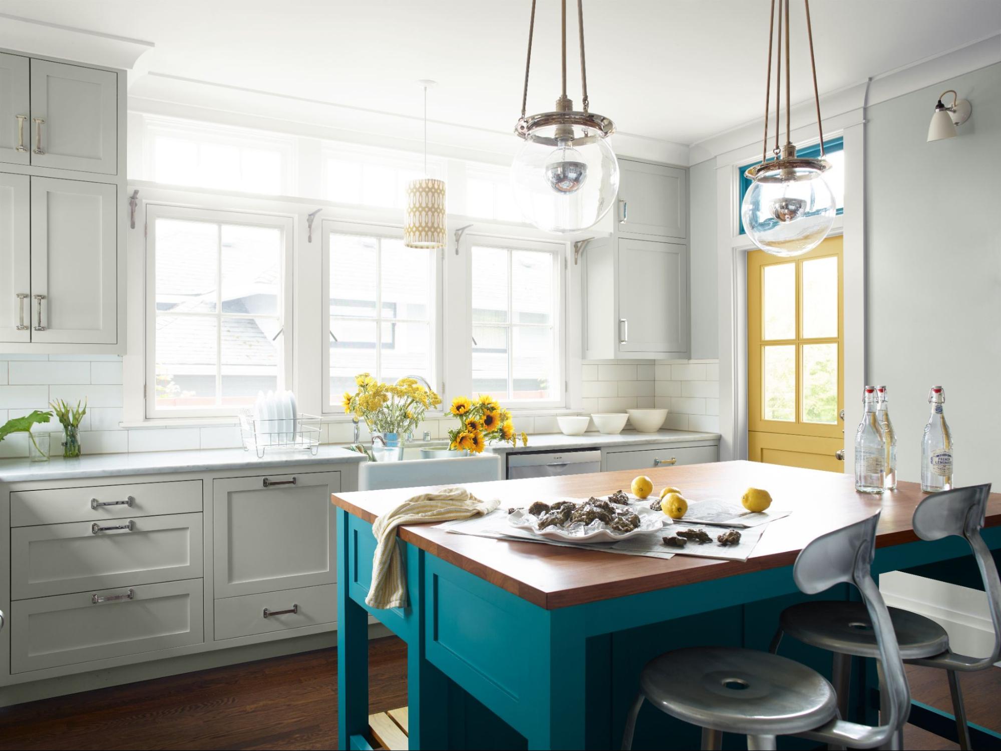 Benjamin Moore Paper White in the kitchen, complemented by bright accent colors.