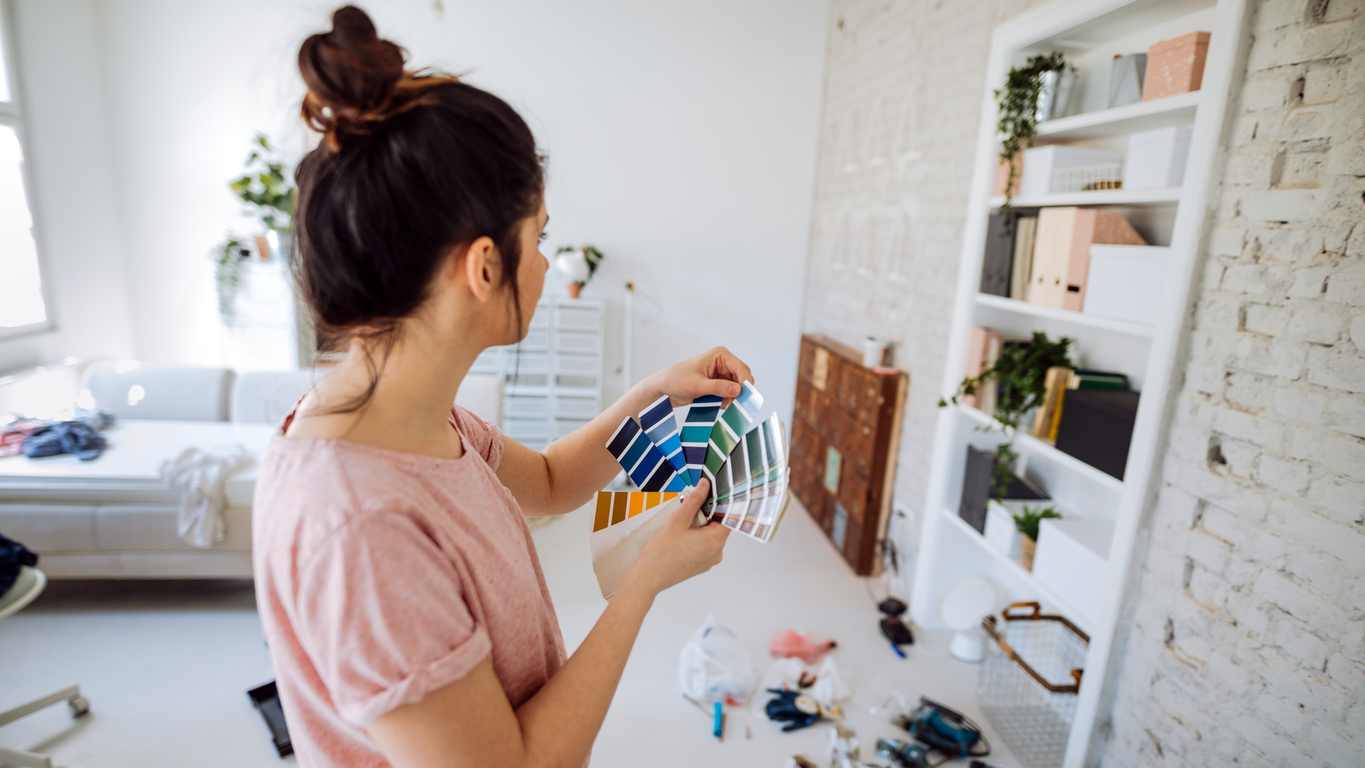 woman using a paint swatches fan deck