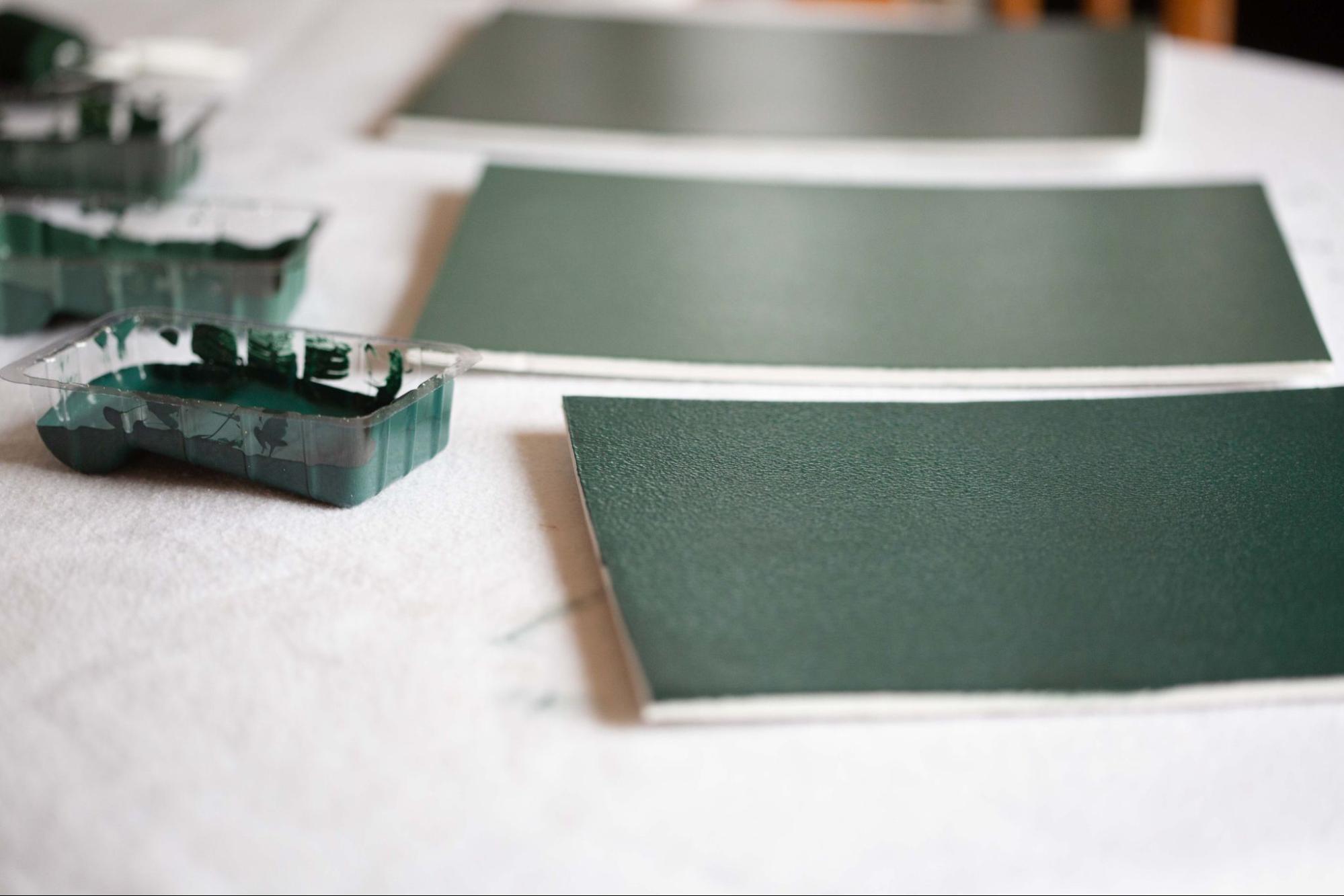 Paint sampling test boards painted in Benjamin Moore green colors