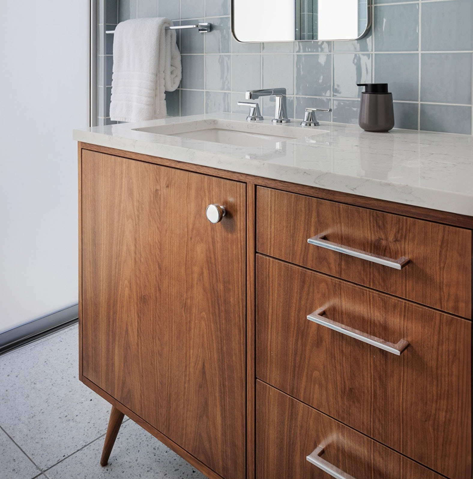 Midcentury modern bathroom cabinet console with silver knobs and pulls