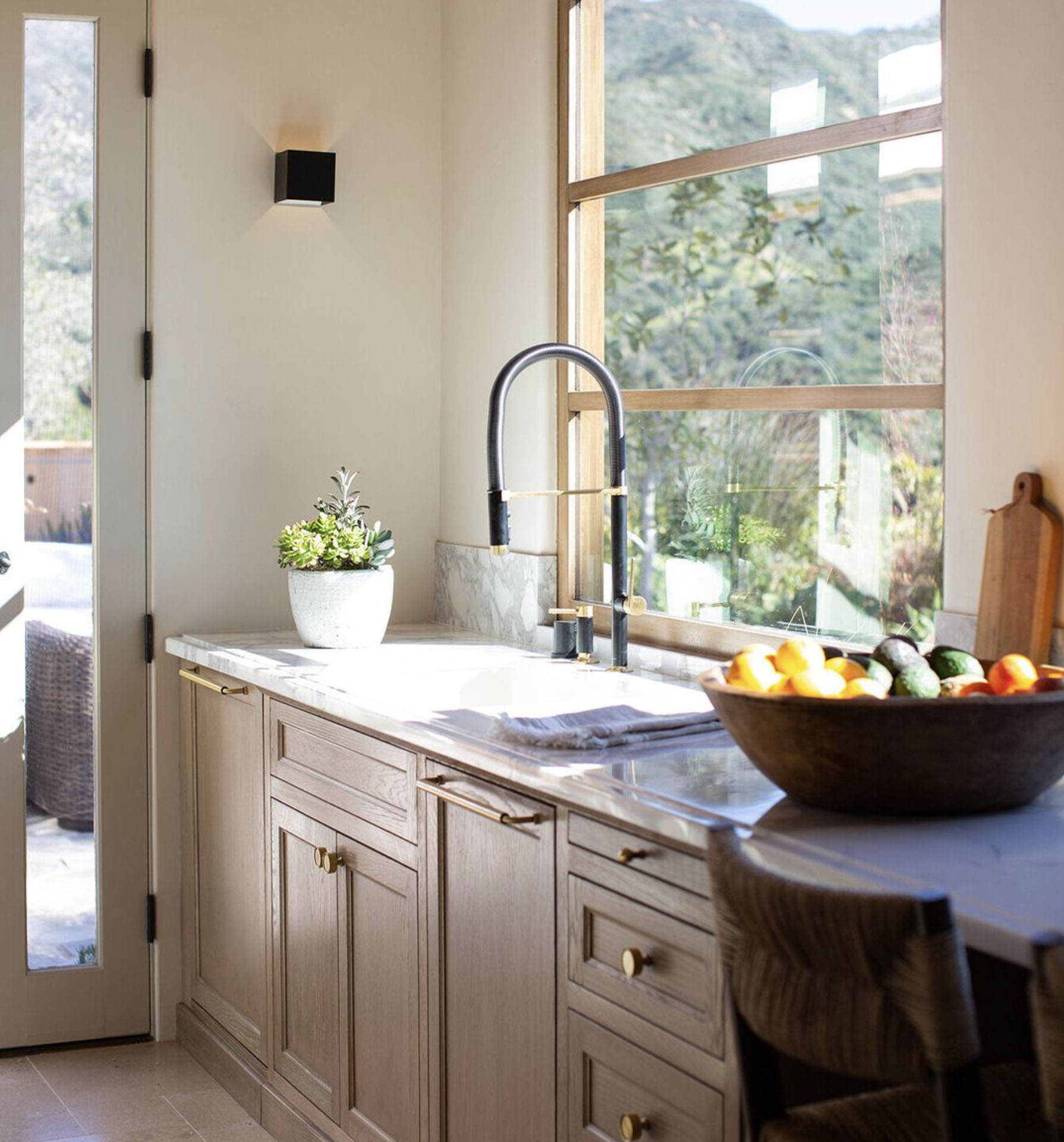 Kitchen with brown wood cabinets and brass hardware 