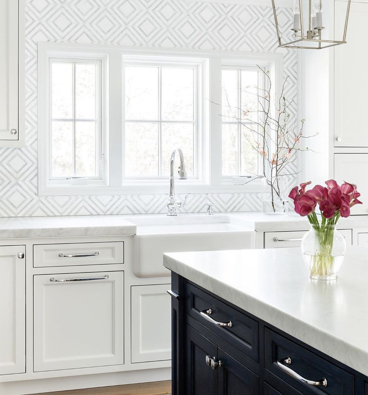 Kitchen with white counter tops and chrome Baldwin hardware