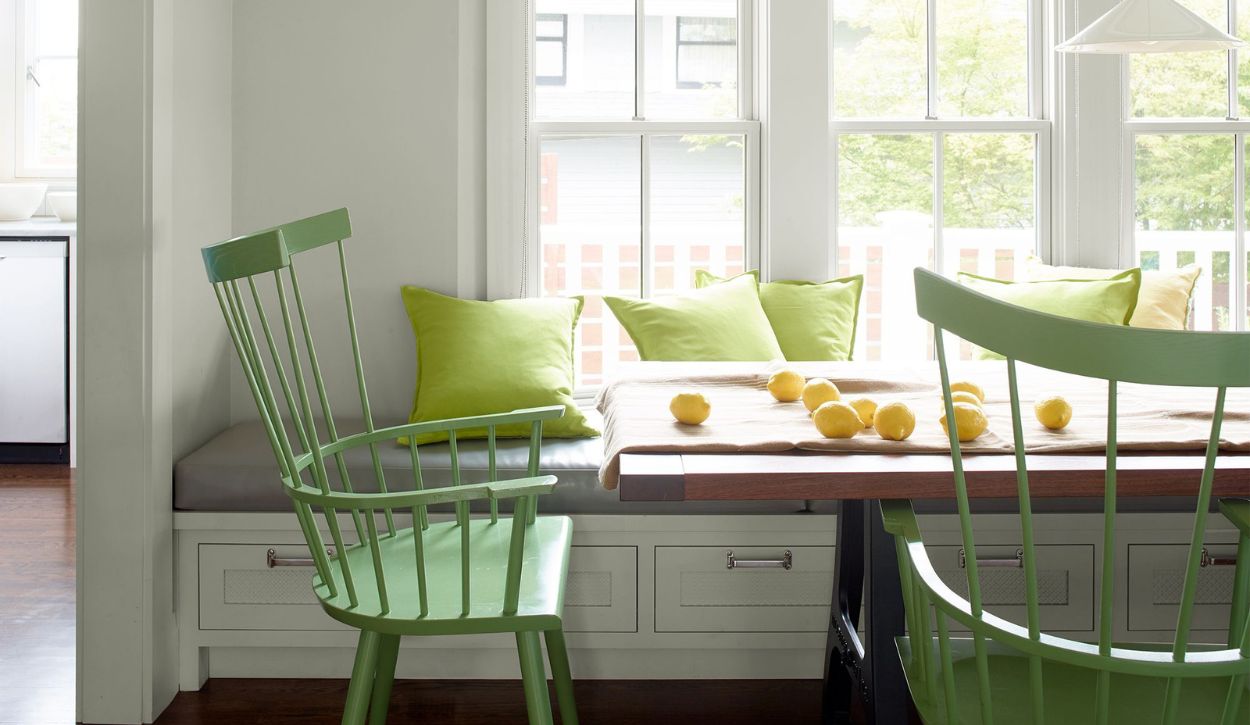 Benjamin Moore Gray Owl dining room walls enhanced by bright citrus-green chairs.