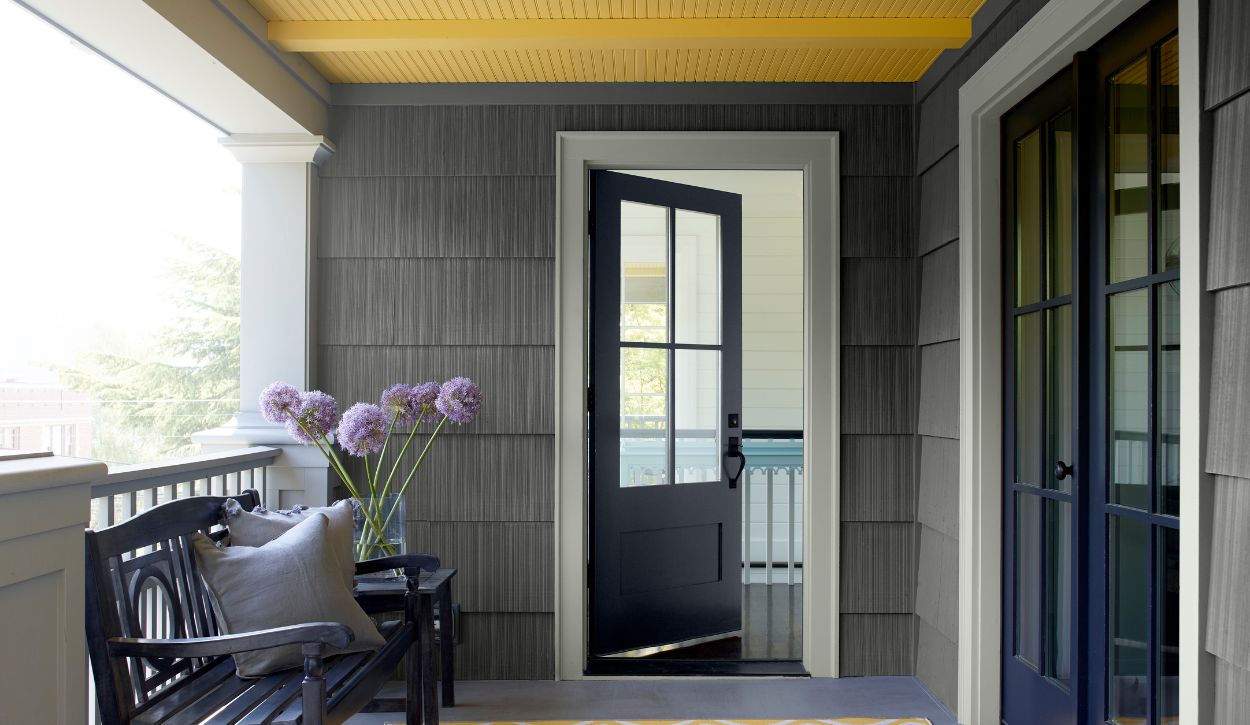 Benjamin Moore Gray Owl OC-52 trim appears almost white against dark gray exterior paint