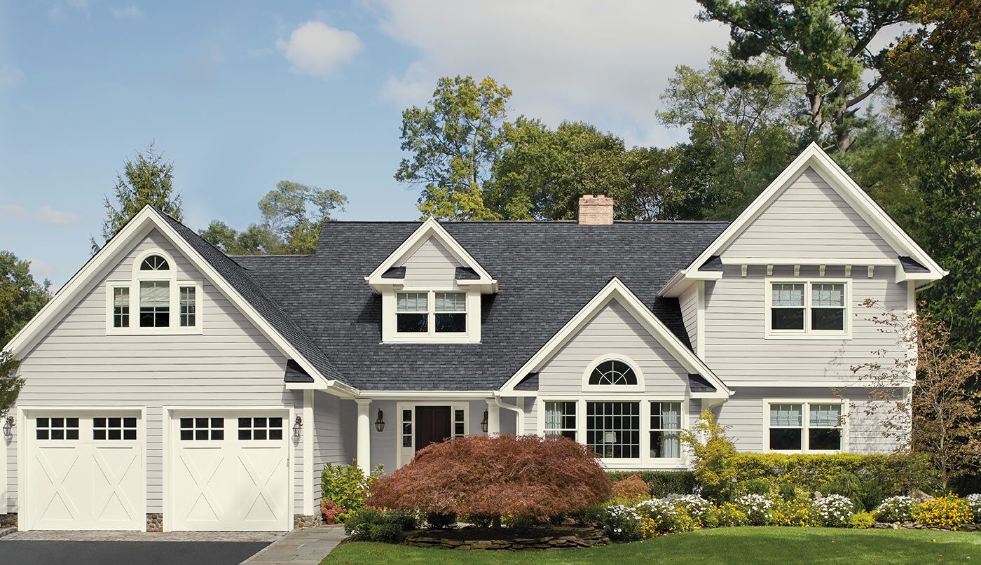 House with siding in Stonington Gray HC-170, trim and garage door in White Wisp OC-54