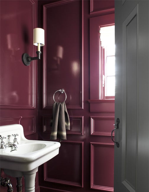 Small powder room painted in Benjamin Carter Plum with a high gloss finish